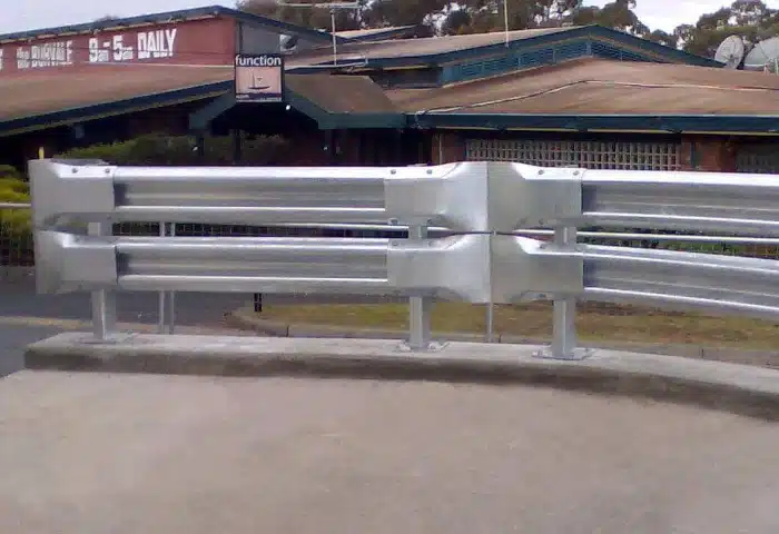 Car park crash barrier and parking barrier system installed around a warehouse