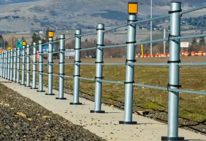 T-18 Log Rail road guardrail installed on a treelined road