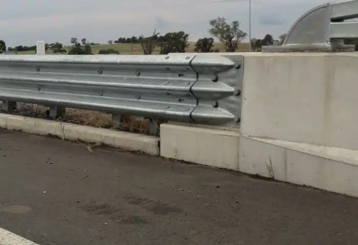 ARMCO road guardrail and safety barrier system installed around shops