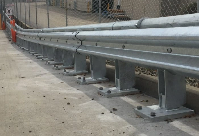 RHINO STOP car park barrier system installed with silver finish in front of warehouse dock
