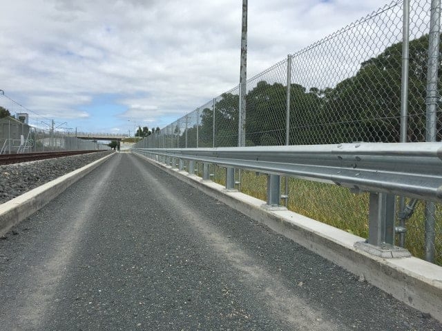 W-Beam Guardrail near steel mesh fence