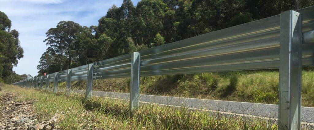 W Beam safety barrier installed on a grass roadside