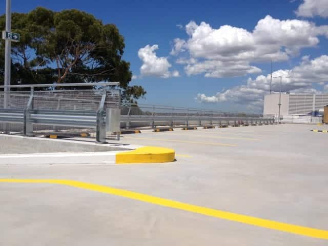 Hurlstone Park RSL Club car park with parking barriers installed near yellow lines and wheel stops