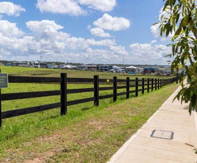 1100m Hardwood timber posts installed near footpath at The Gables, a commercial fencing service provided by metal fencing specialist