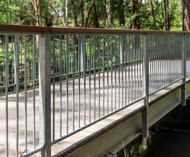 Galvanised pedestrian balustrades installed across bridge in Rouse Hill, a commercial fencing service provided by metal fencing specialist