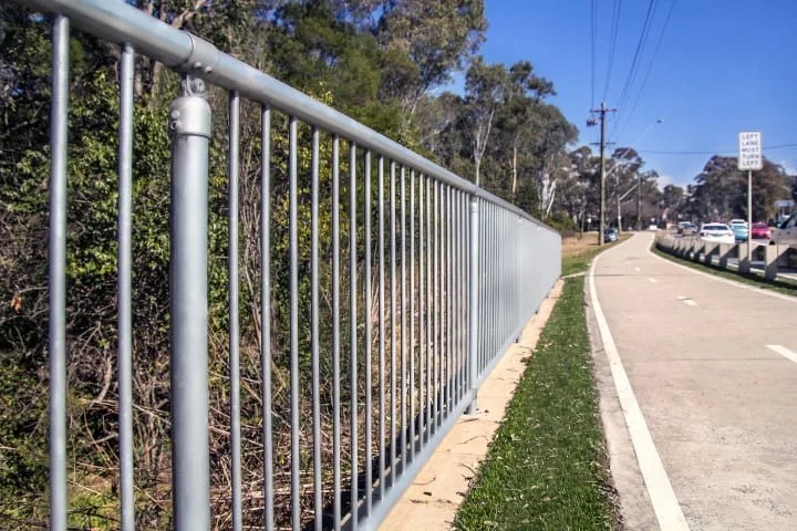 silver double rail handrail installed on a bicycle path